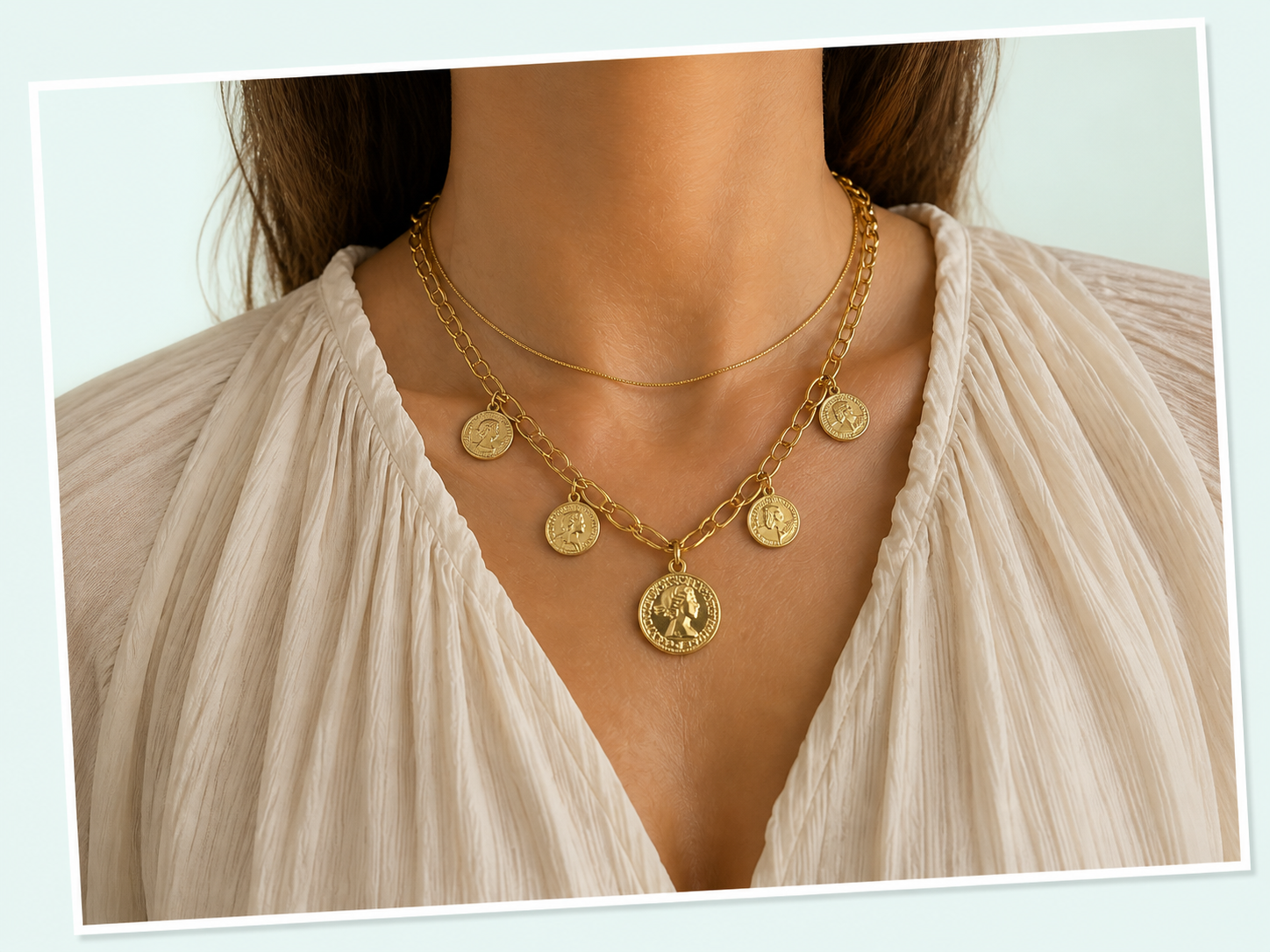 BisuTrendy gold coin necklace on an ivory blouse